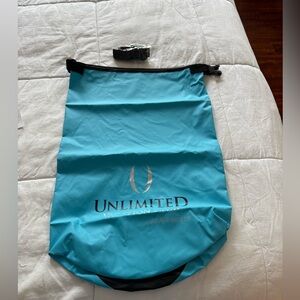 New, blue waterproof bag with strap.